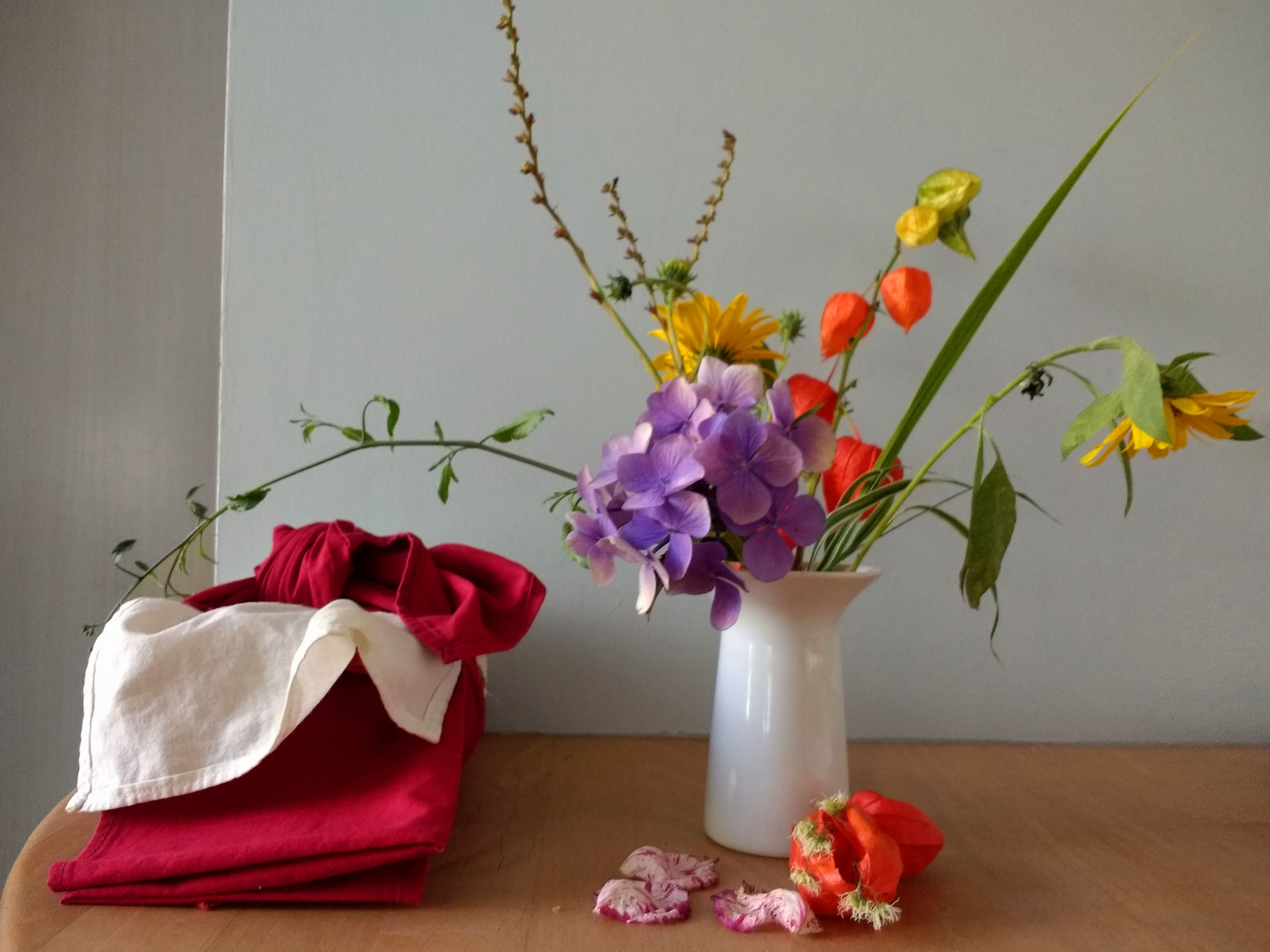 Ikebana botanical arrangement with wild branches in ceramic vessel