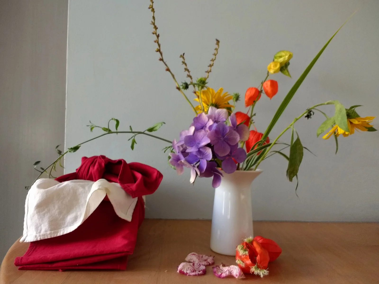Ikebana botanical arrangement with wild branches in ceramic vessel